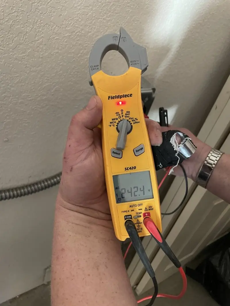 Voltage testing with clamp meter during Recessed Lighting Installation in Shaler